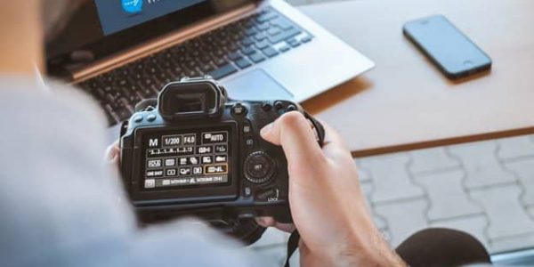 adjusting camera settings during photography in the workplace